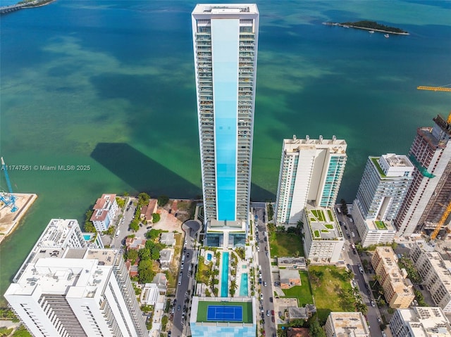 birds eye view of property with a view of city and a water view