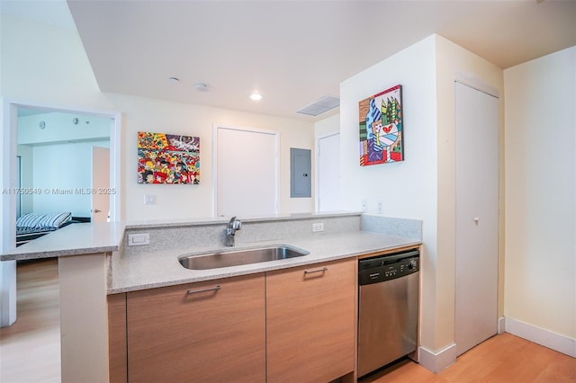 kitchen featuring light wood-style flooring, a sink, electric panel, light stone countertops, and dishwasher