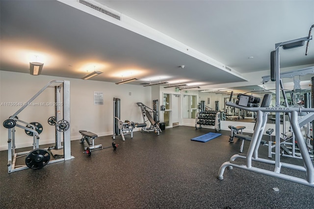 exercise room featuring visible vents and baseboards