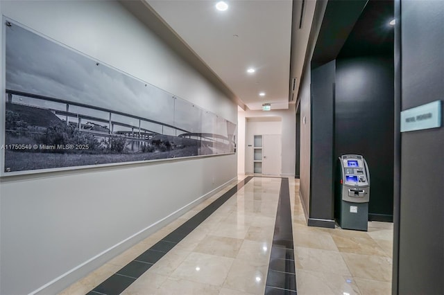 hallway with recessed lighting and baseboards