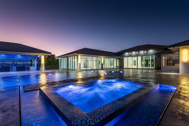 view of pool with an in ground hot tub