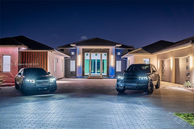 view of front of house featuring driveway and stucco siding