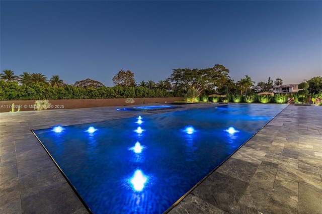 view of swimming pool with an in ground hot tub