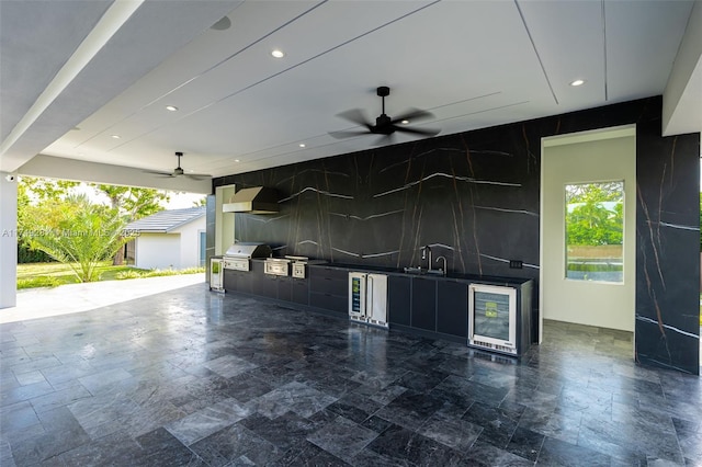 view of patio / terrace with wine cooler, an outdoor kitchen, a grill, and a ceiling fan