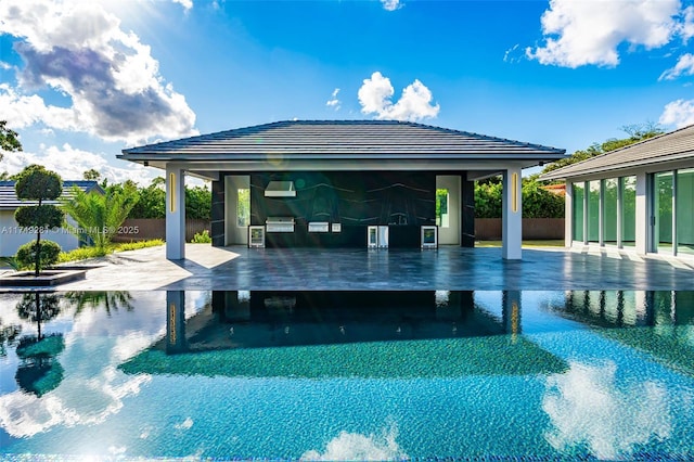 view of swimming pool featuring a swimming pool, area for grilling, a gazebo, and fence