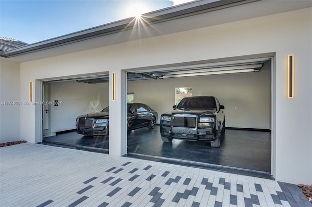 garage with decorative driveway