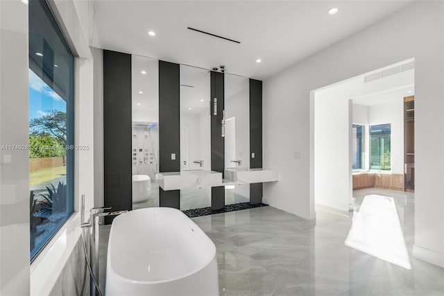 bathroom featuring recessed lighting, visible vents, a freestanding bath, and vanity