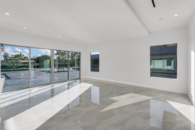 empty room featuring recessed lighting, marble finish floor, and baseboards