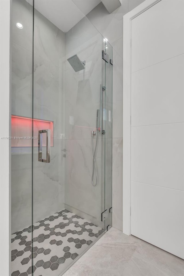 bathroom with a marble finish shower