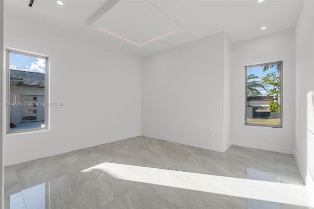 spare room with a wealth of natural light, baseboards, and recessed lighting