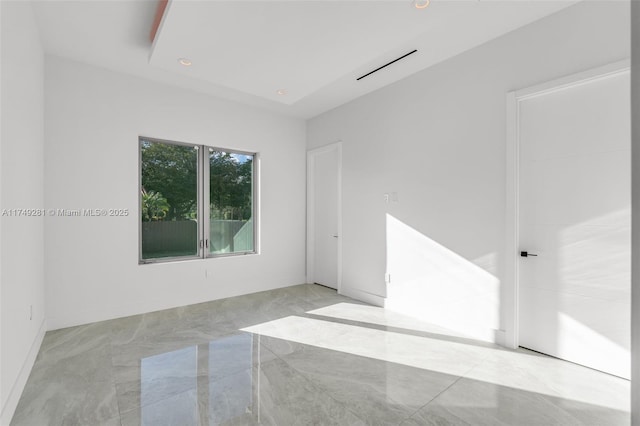 unfurnished room featuring recessed lighting and marble finish floor