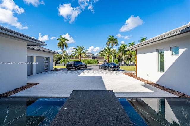 view of car parking featuring decorative driveway