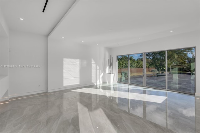 unfurnished room featuring recessed lighting and marble finish floor