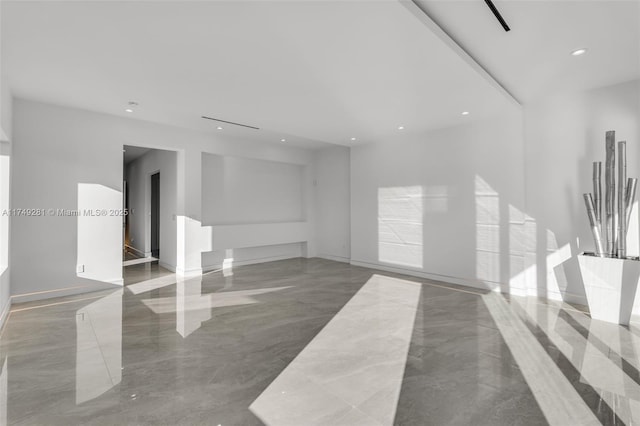 unfurnished living room featuring recessed lighting and marble finish floor