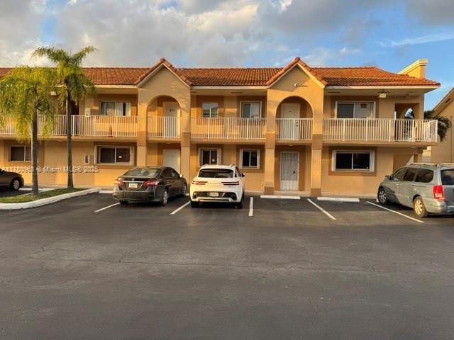 view of building exterior with uncovered parking