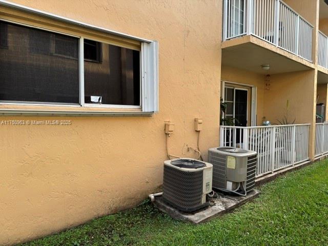 details with cooling unit and stucco siding