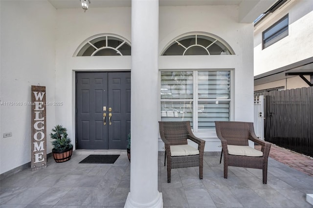 view of exterior entry featuring stucco siding