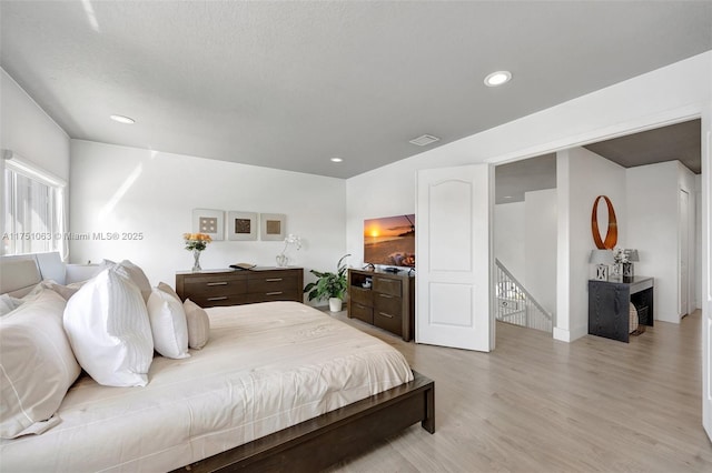 bedroom featuring recessed lighting, visible vents, and light wood-style floors