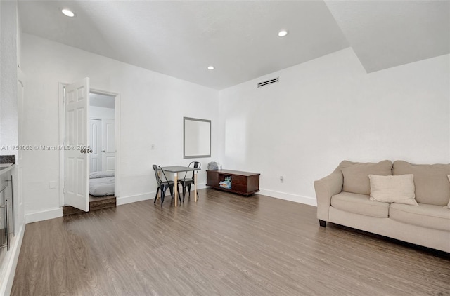 sitting room with recessed lighting, wood finished floors, visible vents, and baseboards