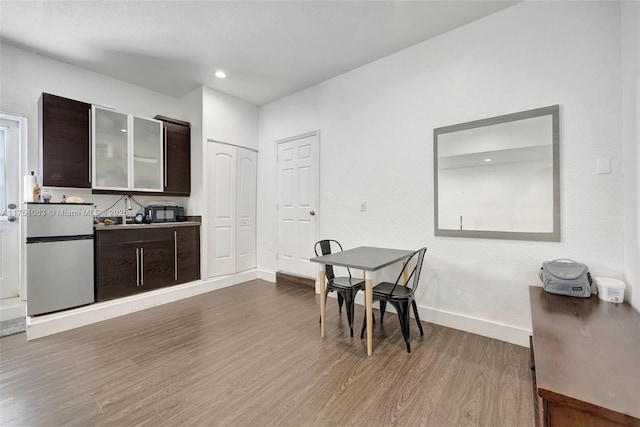 dining area with recessed lighting, baseboards, and wood finished floors