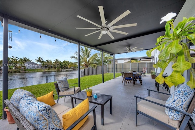 view of patio with ceiling fan, outdoor dining area, a fenced backyard, outdoor lounge area, and a water view