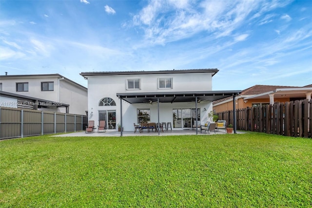 back of property featuring a ceiling fan, a lawn, a patio, and fence