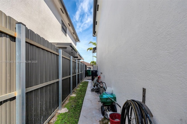 view of home's exterior with fence and stucco siding