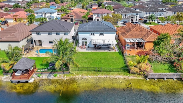 drone / aerial view featuring a water view and a residential view