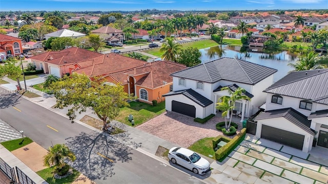 drone / aerial view with a residential view and a water view