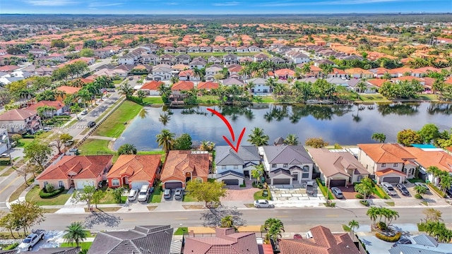 drone / aerial view featuring a residential view and a water view