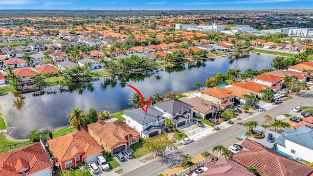 drone / aerial view featuring a residential view and a water view