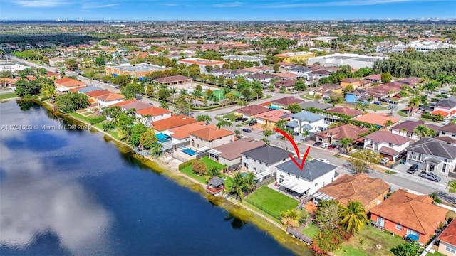 birds eye view of property featuring a water view and a residential view