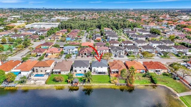 birds eye view of property featuring a residential view and a water view