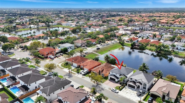 aerial view with a water view and a residential view