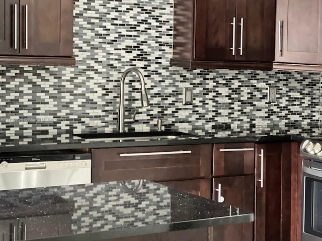 kitchen with a sink, dark brown cabinets, stainless steel appliances, and decorative backsplash