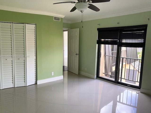 unfurnished bedroom featuring crown molding, light tile patterned floors, a closet, visible vents, and baseboards