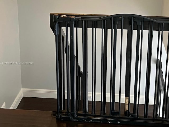 room details with baseboards, radiator heating unit, and wood finished floors