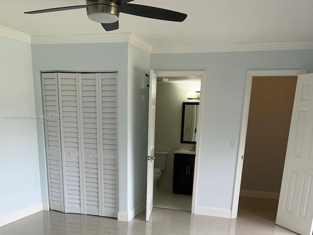 unfurnished bedroom with a ceiling fan, ensuite bath, ornamental molding, and baseboards