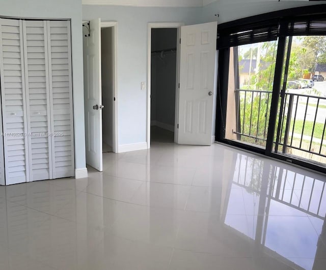 unfurnished bedroom featuring baseboards and light tile patterned floors