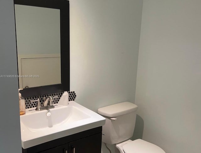 bathroom featuring toilet and vanity