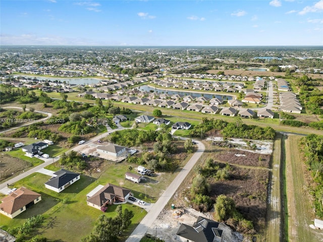 birds eye view of property with a water view and a residential view