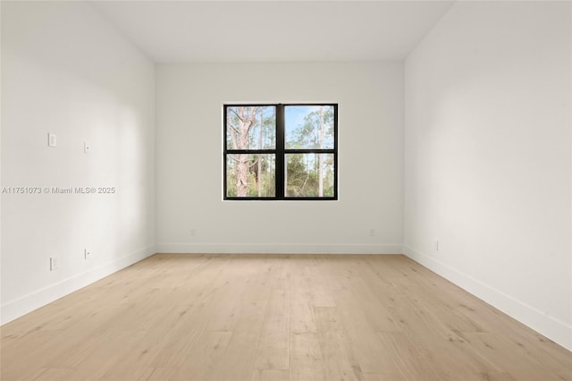 unfurnished room featuring light wood finished floors and baseboards