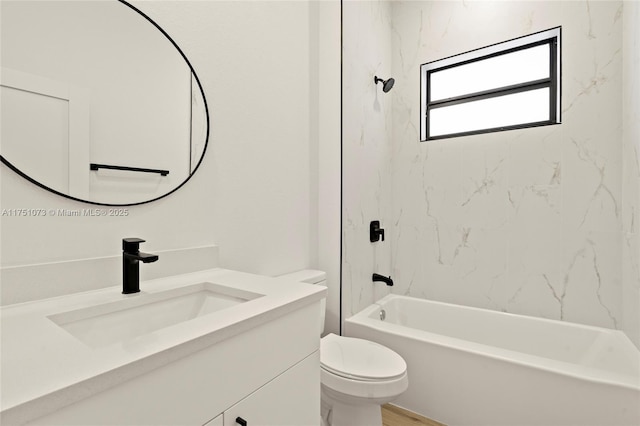 bathroom with washtub / shower combination, vanity, and toilet