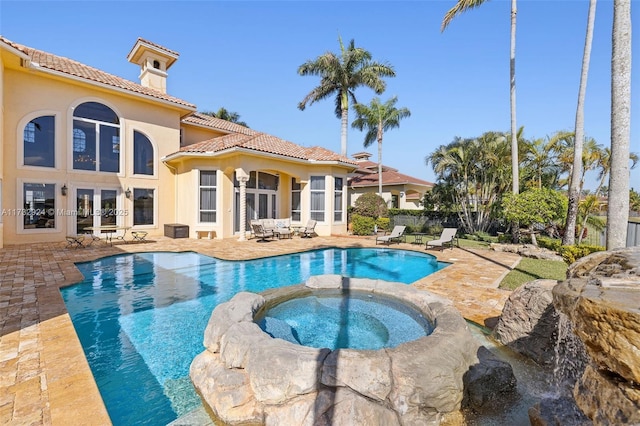 view of pool featuring a patio area and a pool with connected hot tub