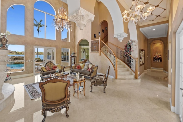 living room featuring stairs, arched walkways, crown molding, and an inviting chandelier