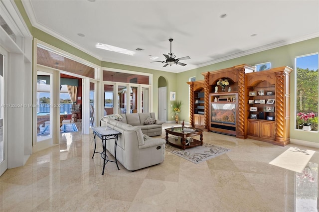 living room with arched walkways, visible vents, a ceiling fan, french doors, and ornamental molding