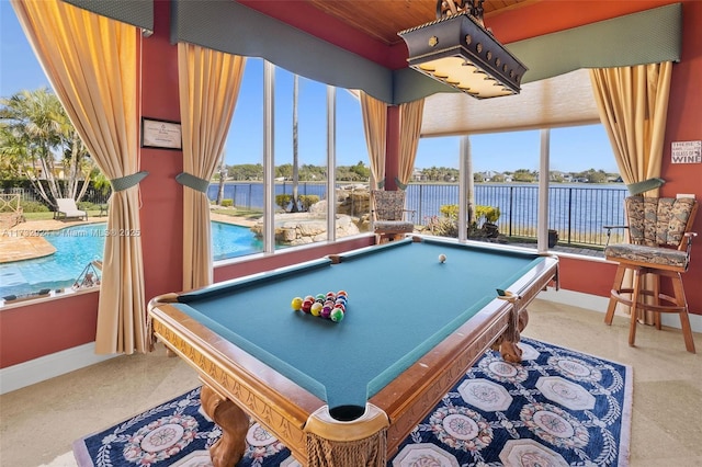 game room featuring a water view, billiards, and baseboards