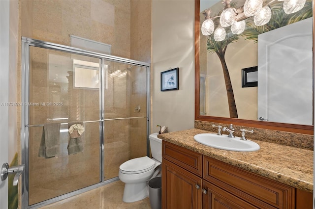 bathroom featuring toilet, a stall shower, and vanity