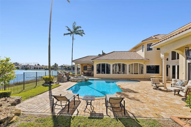 view of swimming pool with a pool with connected hot tub, a fenced backyard, and a patio