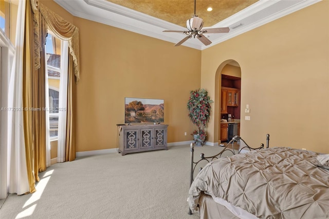 bedroom with arched walkways, a raised ceiling, visible vents, light colored carpet, and ornamental molding